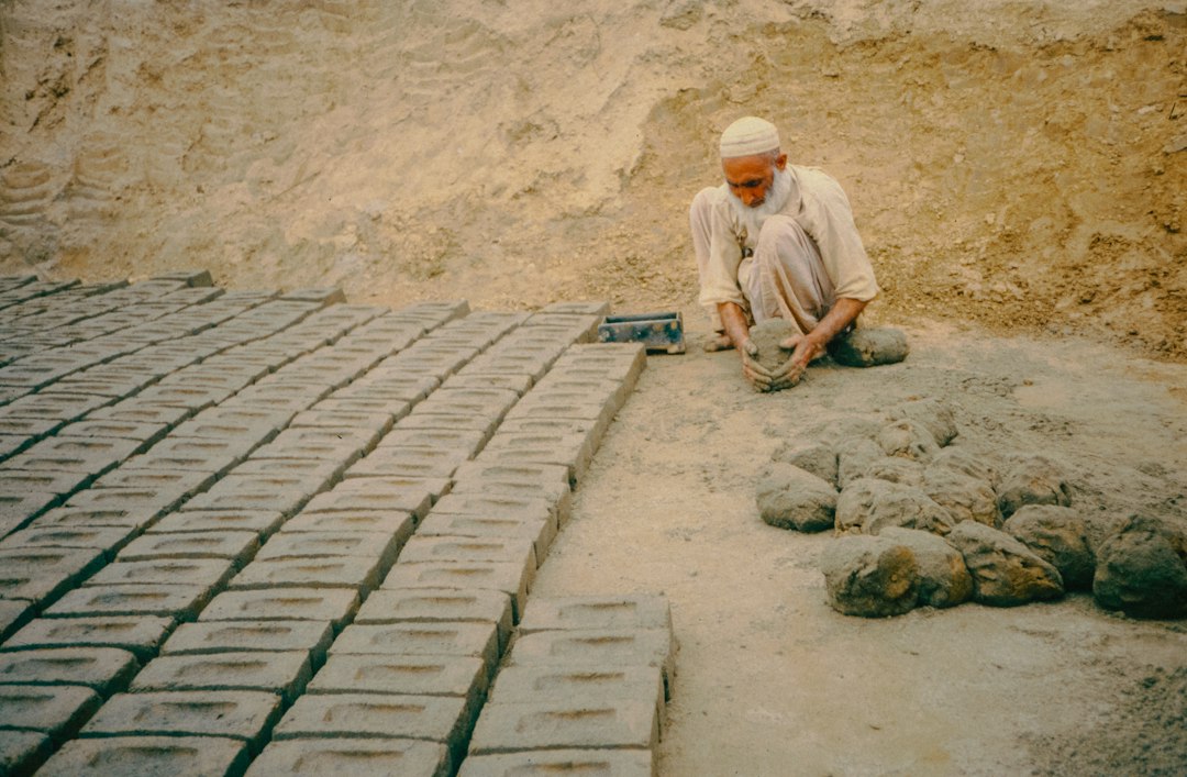 A man is making bricks in the soil